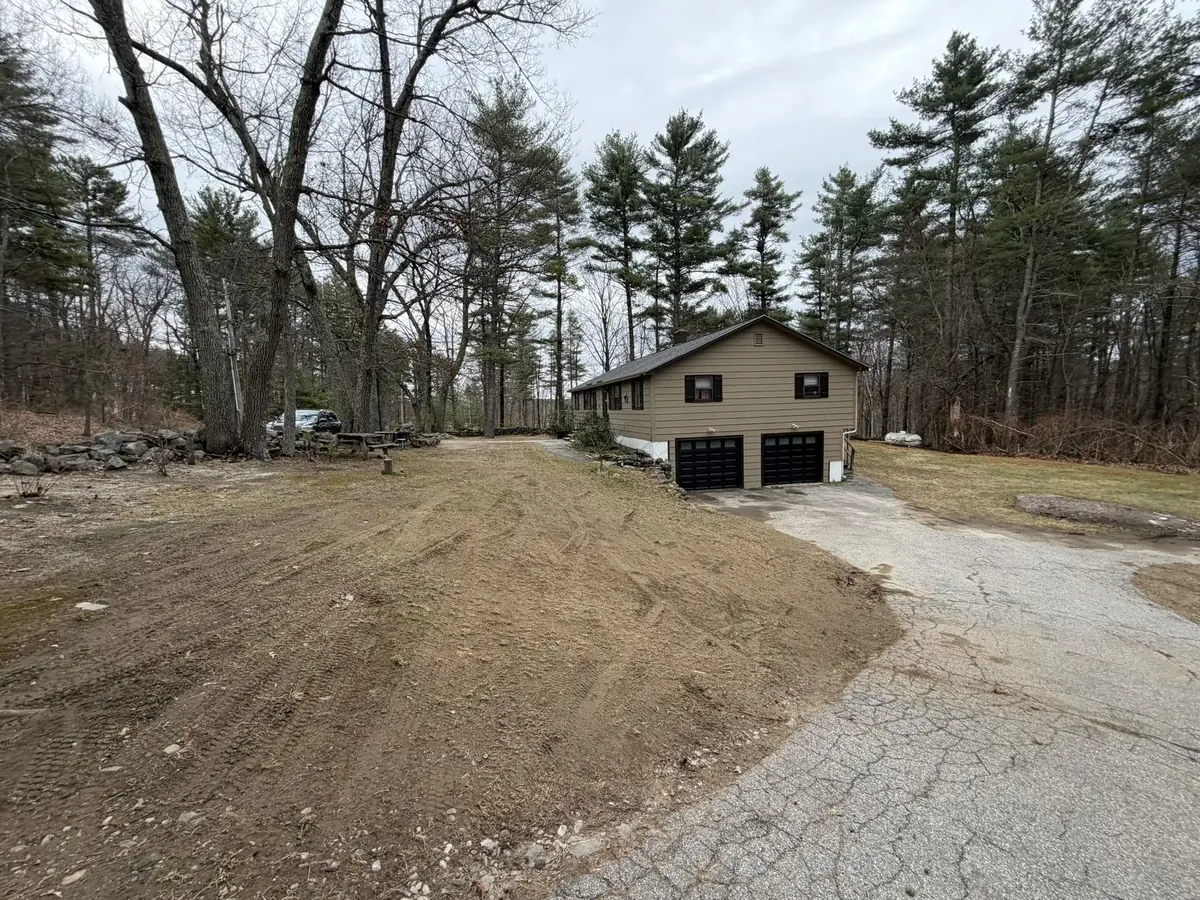 Same front yard cleared, regraded and loamed after a full spring cleanup and regrade