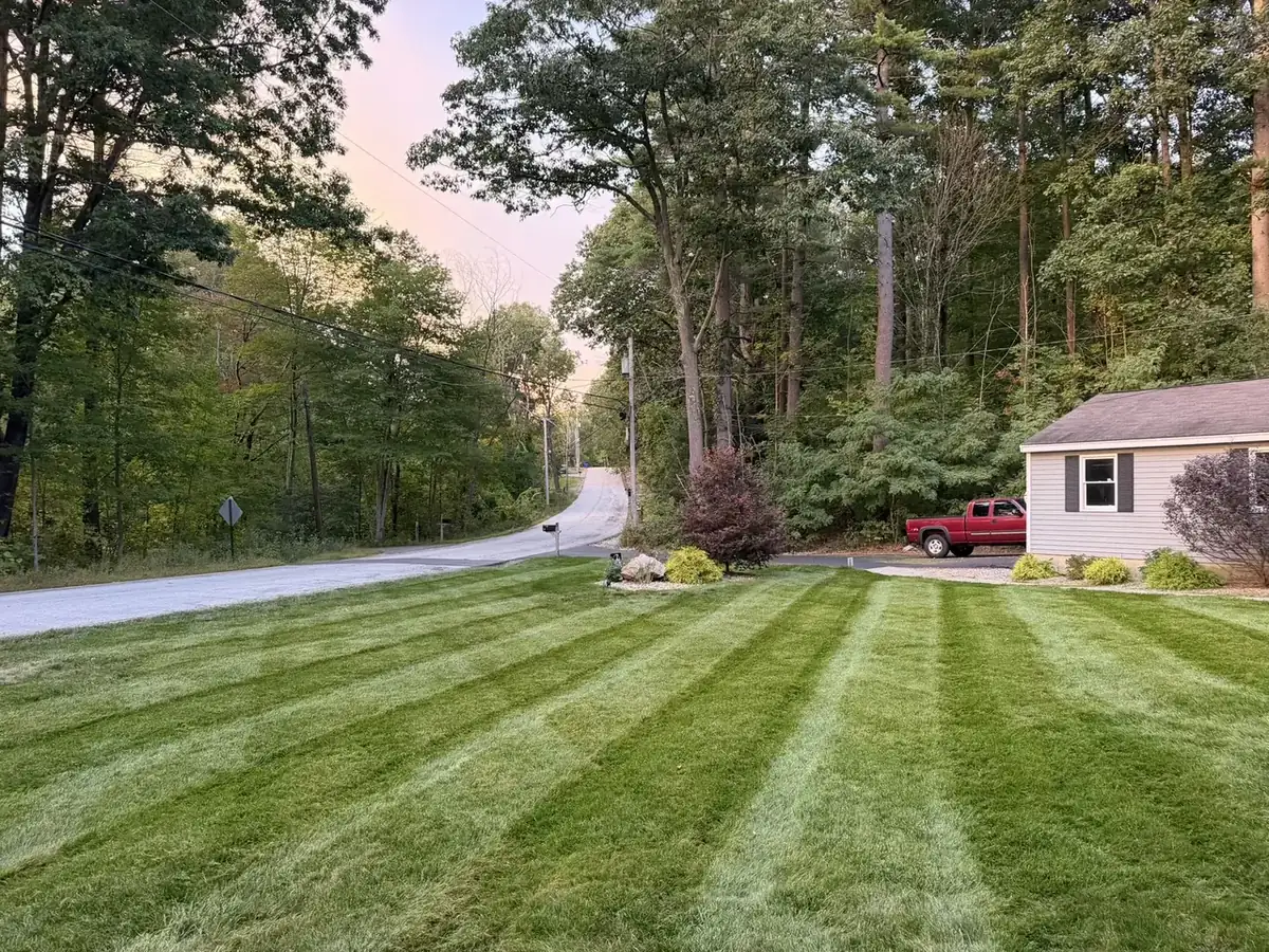Striped roadside front lawn after a weekly mow in Southern New Hampshire