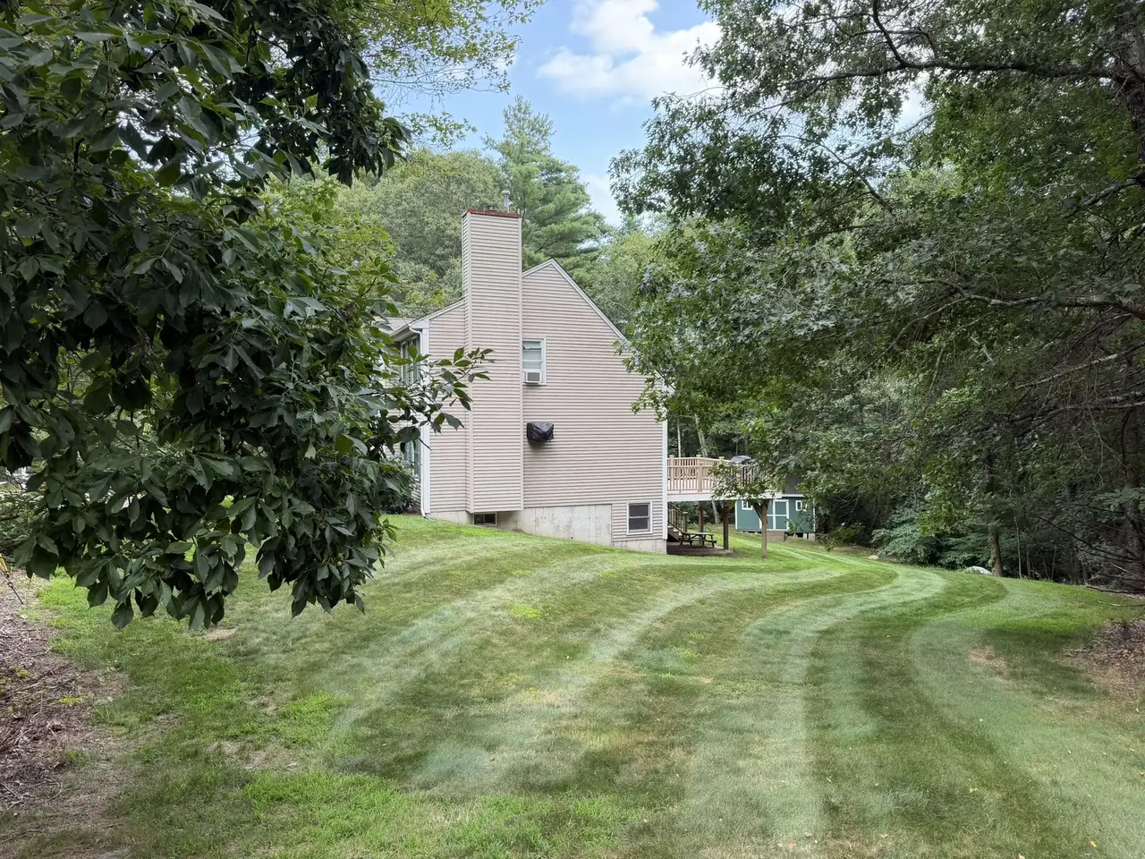 Curved mowing stripes on a side yard in Southern New Hampshire