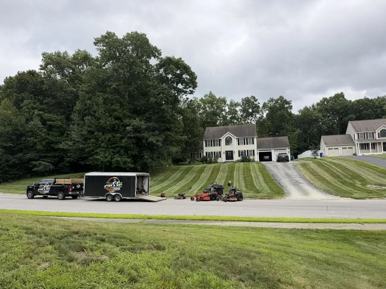 Craig Property Maintenance crew and mowing fleet on a residential street in Hudson NH