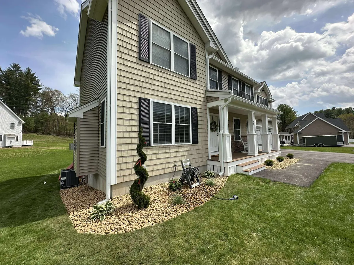Foundation landscaping detail with river rock borders and clean edging in Hudson NH