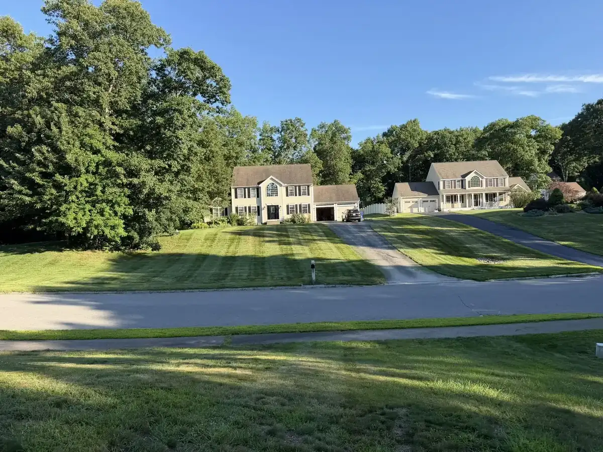 Neighboring striped lawns maintained on the same route in Southern New Hampshire